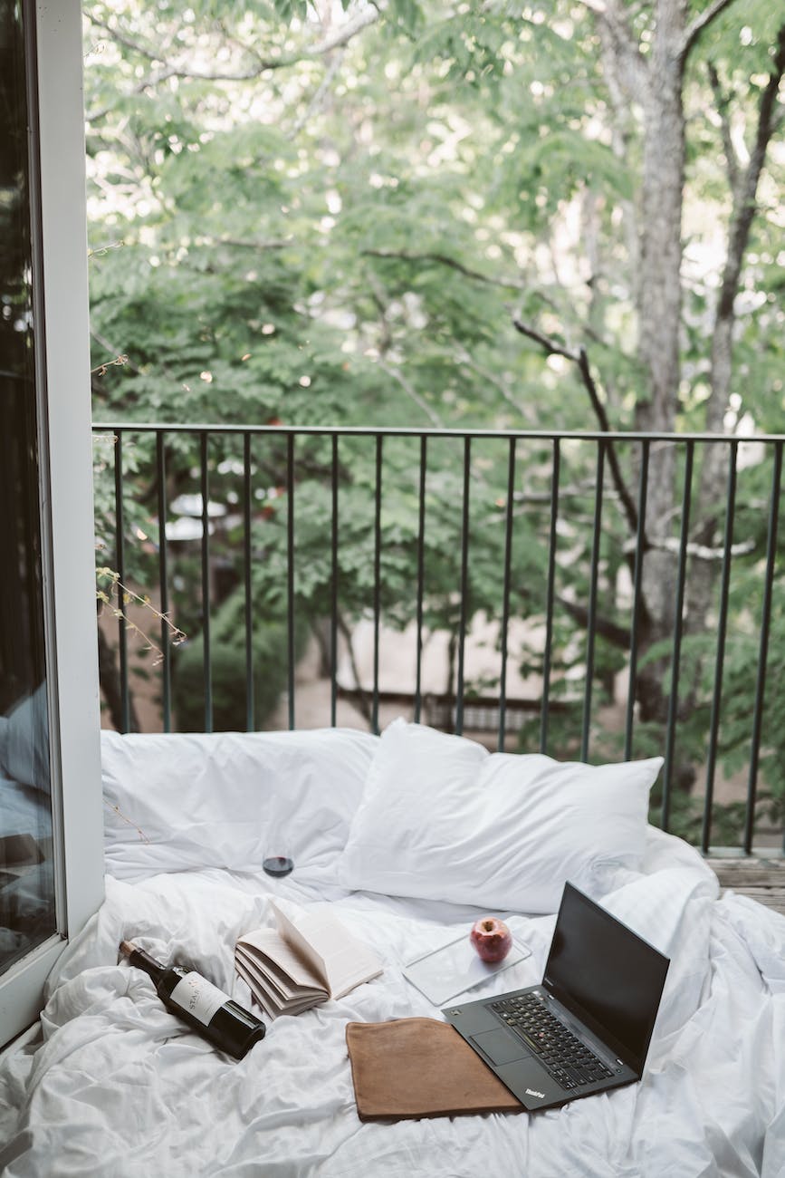 laptop on bed near the balcony